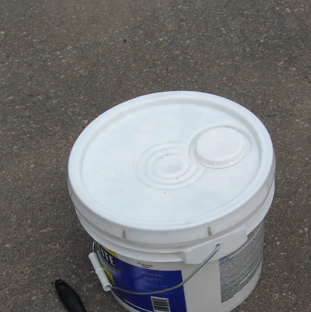 White plastic pail with a lid, seen from above